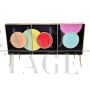 Three-door sideboard in black glass with colored circles