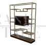 Design bookcase in brass and makassar with central display case