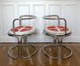 Pair of armchairs by Gae Aulenti in chromed steel                            
