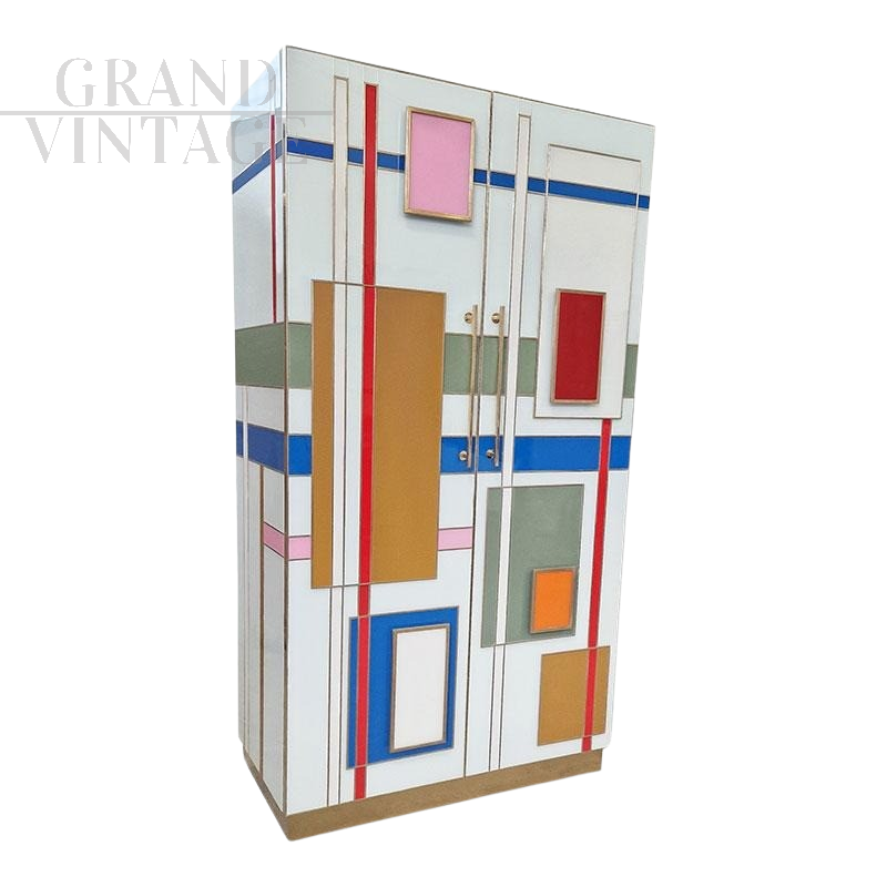 Design wardrobe covered in multicolored glass and with illuminated interiors