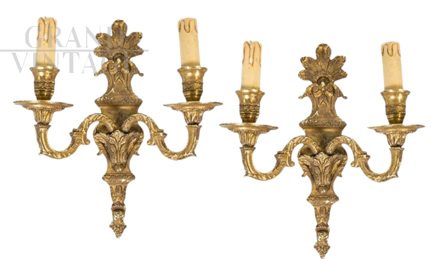 Pair of baroque style wall lights in golden brass