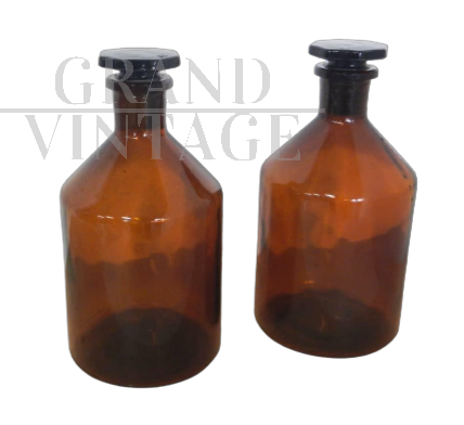 Pair of vintage glass apothecary bottles with stopper             