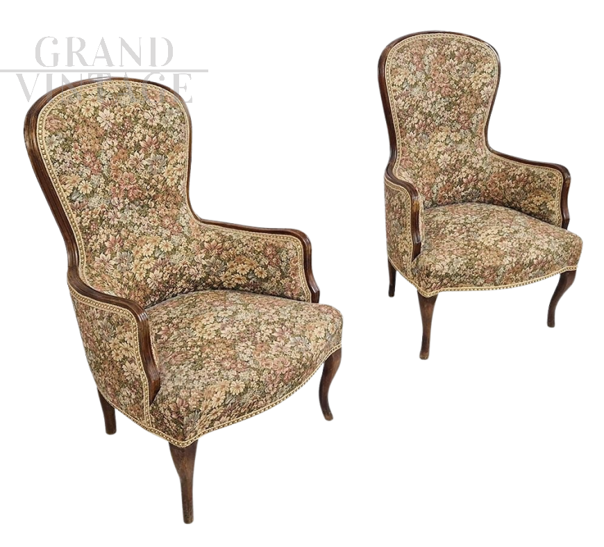Pair of vintage wooden armchairs covered with floral fabric