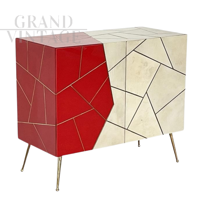 Design sideboard covered in red and parchment-colored glass
