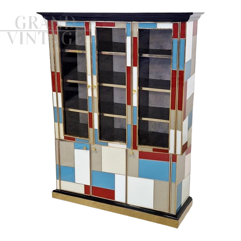 Large bookcase covered in colored glass and illuminated