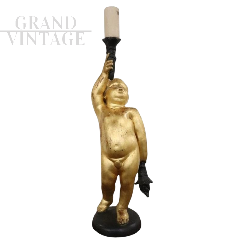 Antique style candle holder with gilded cherub