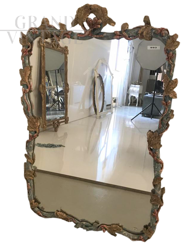Hand carved mirror in antique style and painted with pastel polychrome colors