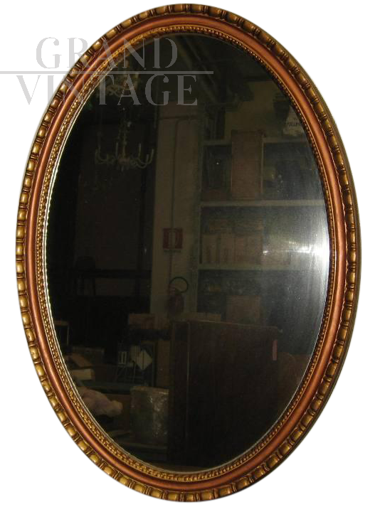 Vintage gilded oval mirror in imitation gold