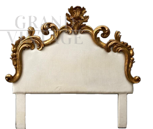Antique bed headboard upholstered in white fabric and carved with gold leaf                         
                            